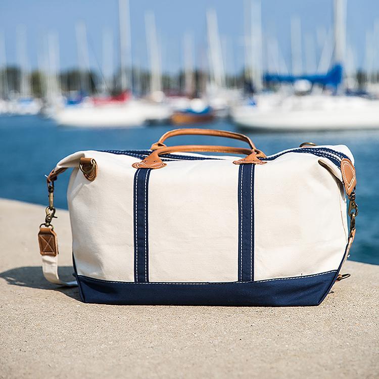 Weekender Duffel bag featuring real leather trim and antiqued brass hardware, made of heavyweight cotton canvas, perfect for travel.