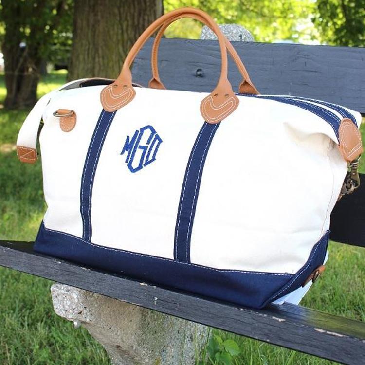 Weekender Duffel bag featuring real leather trim and antiqued brass hardware, made of heavyweight cotton canvas, perfect for travel.