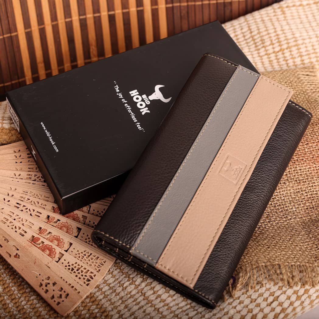 Women vintage wallet made of genuine leather in black and brown colors, showcasing its elegant design and multiple compartments.