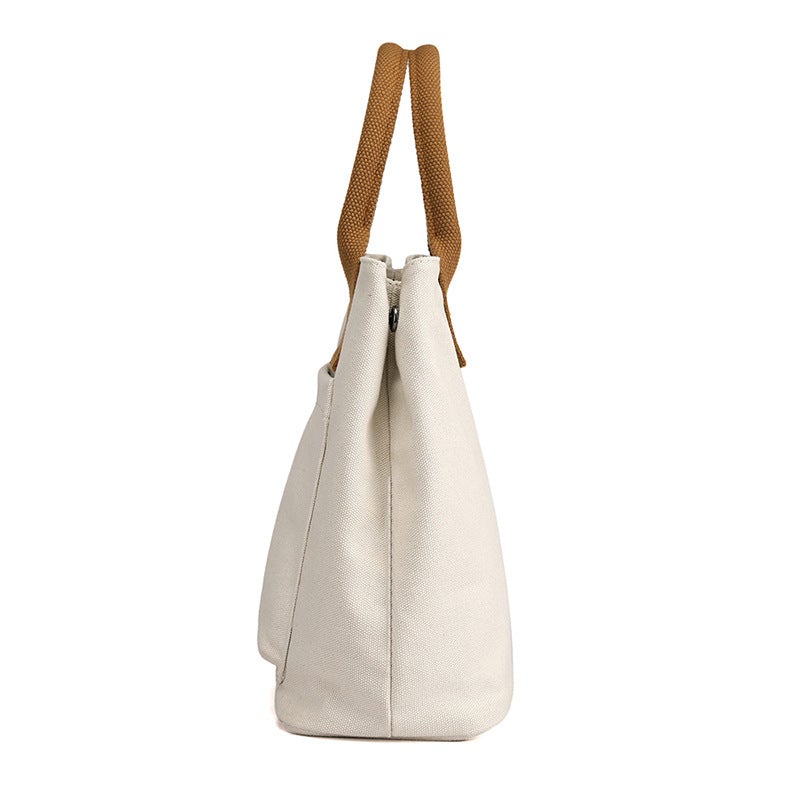 A stylish Women's Casual Canvas Cloth Fashion Handbag in various colors including white, khaki, black, brown, and gray, showcasing its soft surface and compact design.