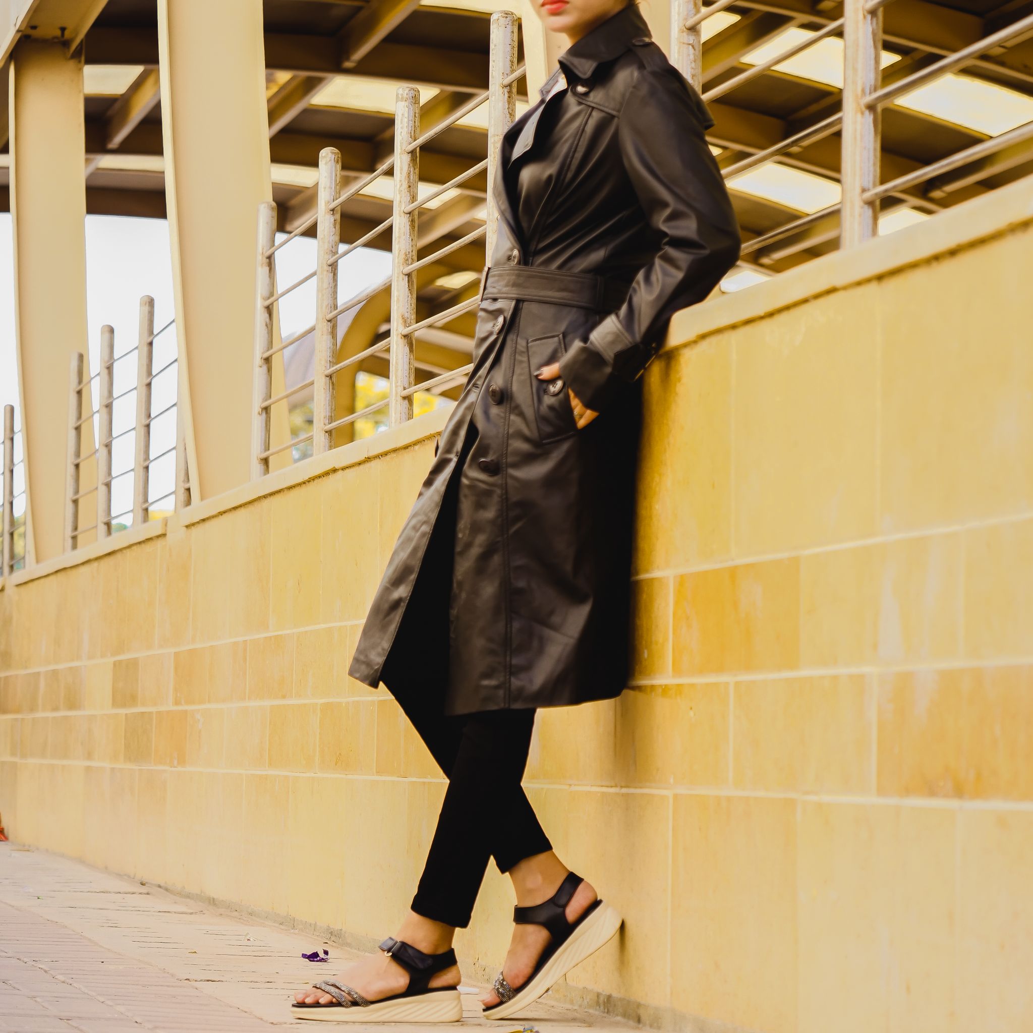 A stylish Women's Leather Long Coat in Black, featuring a double-breasted design and adjustable belt, made from 100% real lambskin leather.