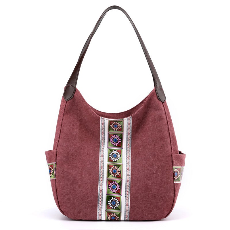 Women's one-shoulder canvas shoulder messenger bag in plain design, showcasing its spacious interior and stylish appearance.