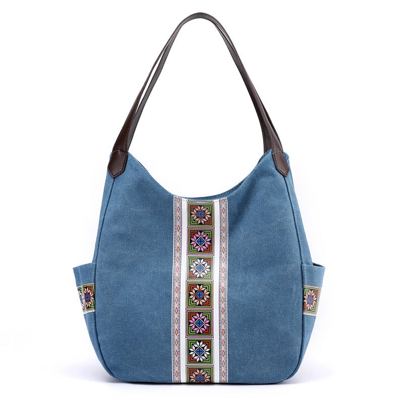 Women's one-shoulder canvas shoulder messenger bag in plain design, showcasing its spacious interior and stylish appearance.