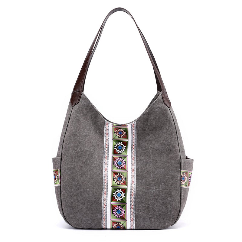 Women's one-shoulder canvas shoulder messenger bag in plain design, showcasing its spacious interior and stylish appearance.