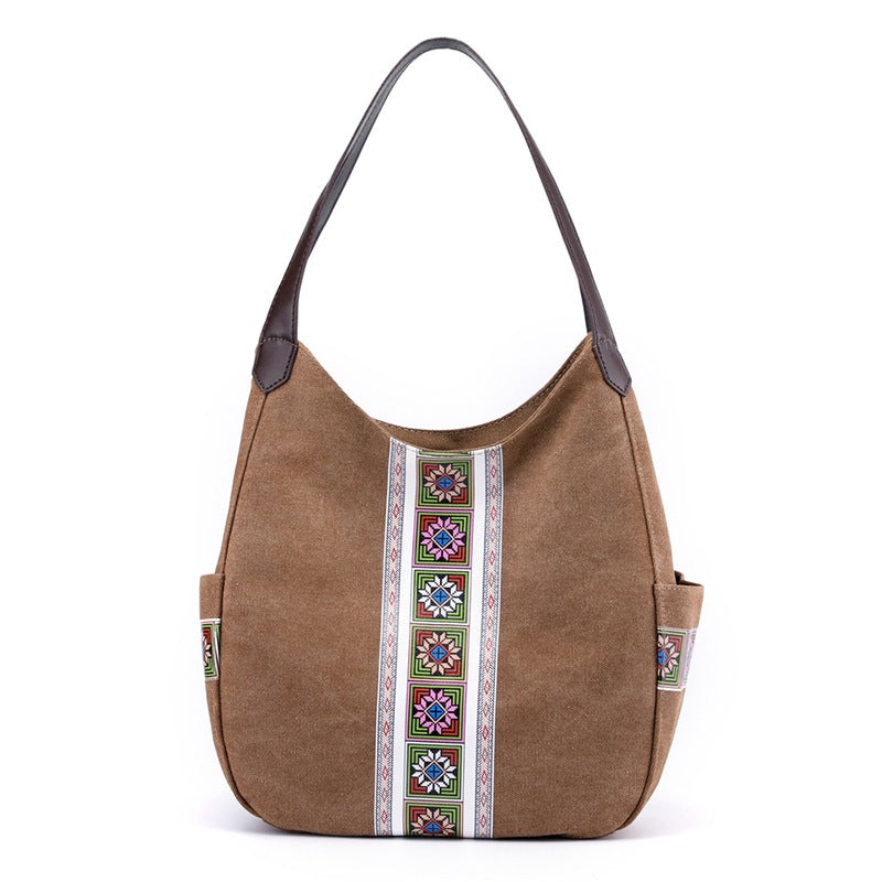 Women's one-shoulder canvas shoulder messenger bag in plain design, showcasing its spacious interior and stylish appearance.