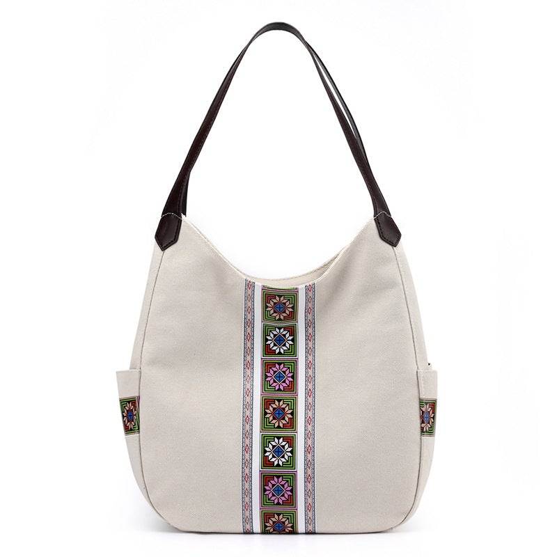 Women's one-shoulder canvas shoulder messenger bag in plain design, showcasing its spacious interior and stylish appearance.