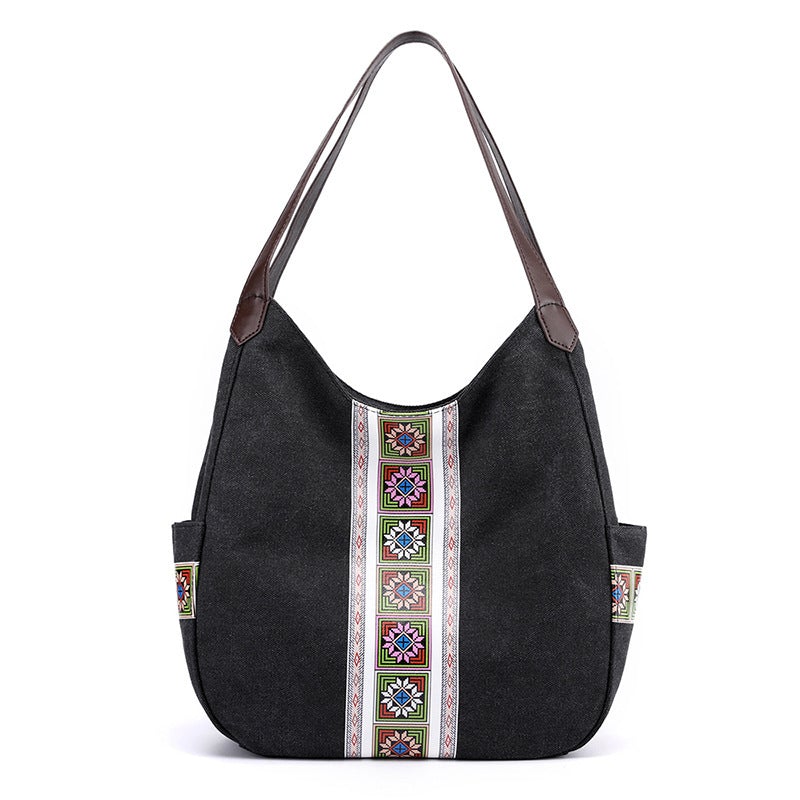 Women's one-shoulder canvas shoulder messenger bag in plain design, showcasing its spacious interior and stylish appearance.