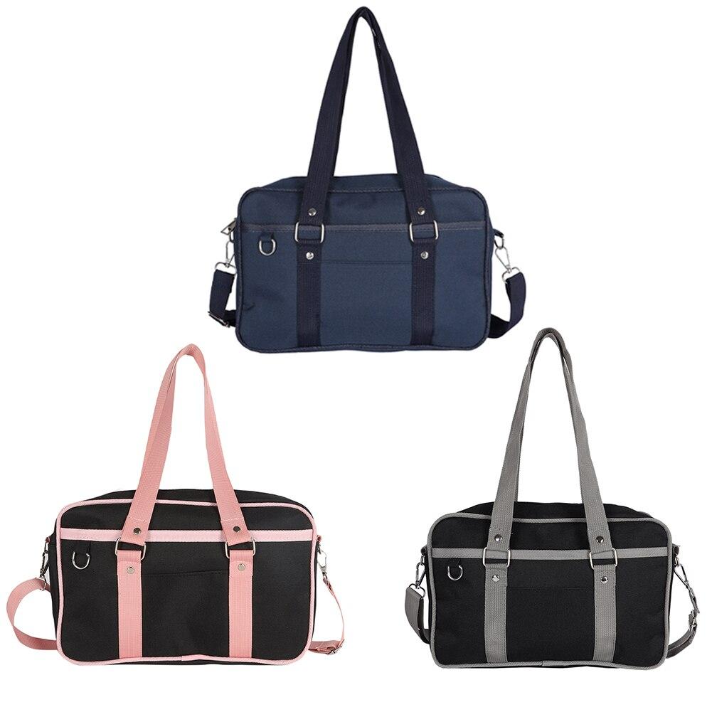 A stylish Women's Contrast Color Canvas Messenger Bag in blue, pink, and black, showcasing its adjustable strap and zipper closure.