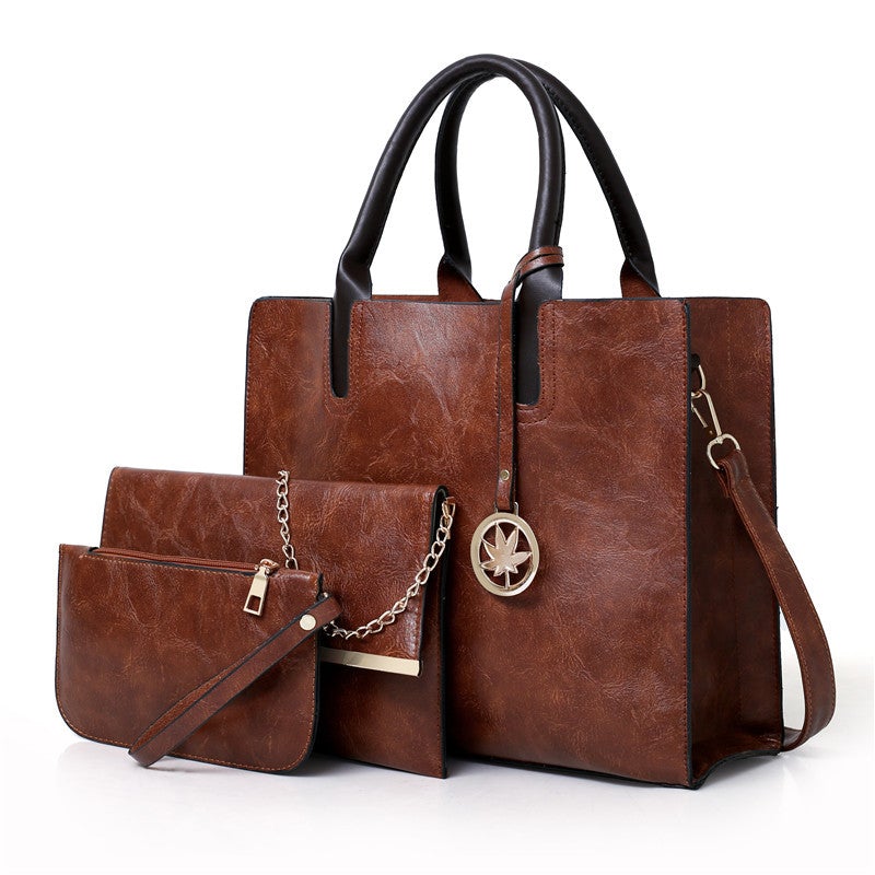 A stylish three-piece set of women's leisure fashion handbags in various sizes, showcasing a modern design with PU fabric and polyester lining.