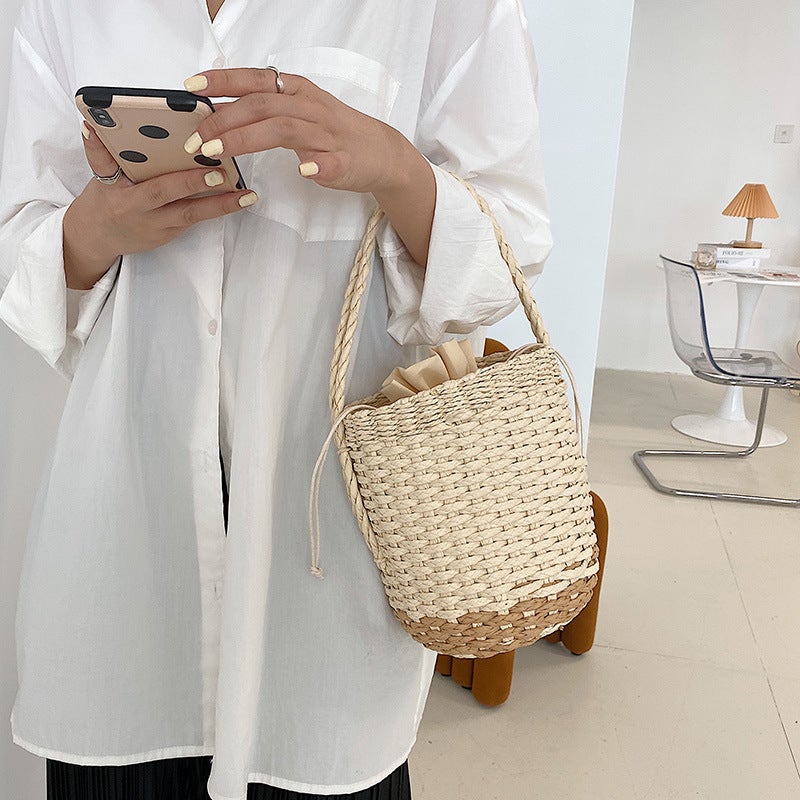 A stylish Young Lady's Leisure Bucket Straw Bag in white and yellow, showcasing its urban simplicity design and single strap.