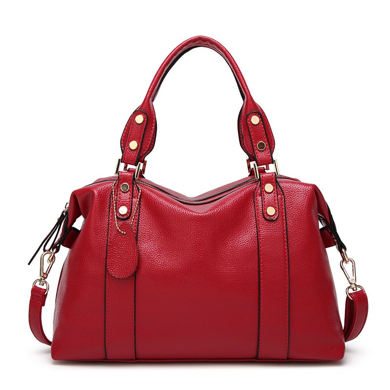 Young Women's Fashionable Casual Leather Messenger Bag in wine red with lychee pattern, showcasing its stylish design and spacious interior.