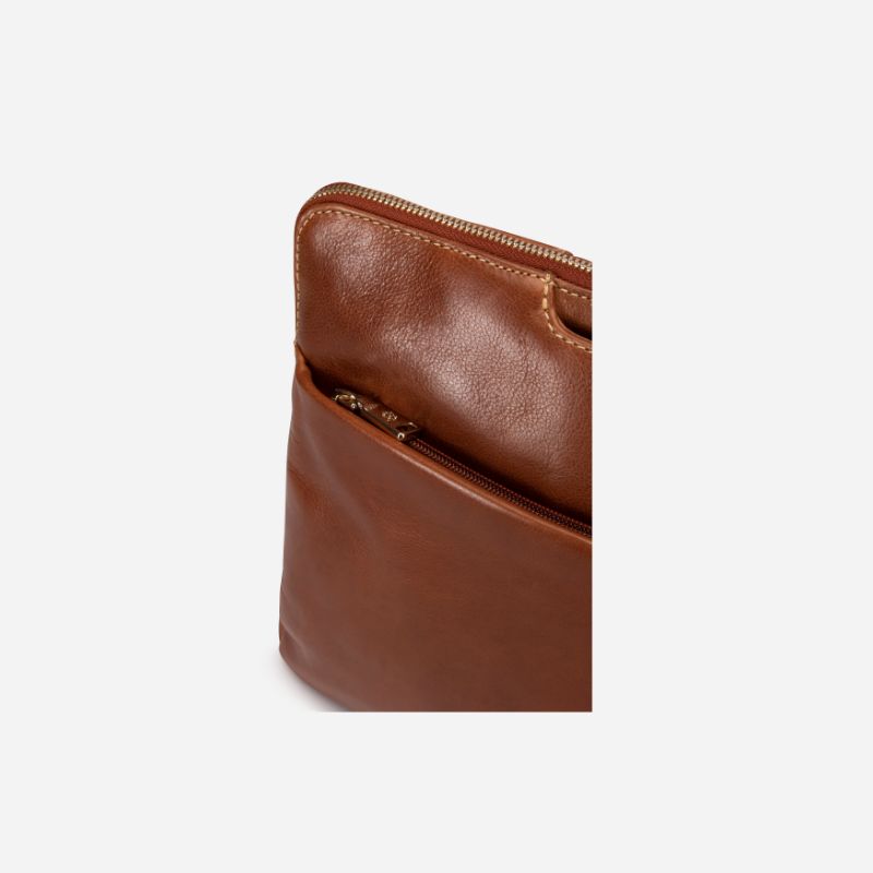 Zulu Laptop Sleeve in tan, featuring a sleek design and shoulder strap loops for easy carrying.