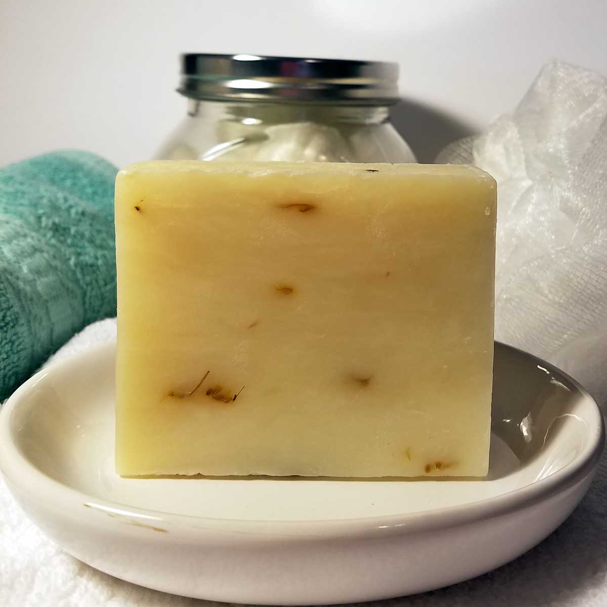 Aloe and Calendula Handmade Soap bar with natural ingredients, showcasing its rich texture and vibrant calendula petals.