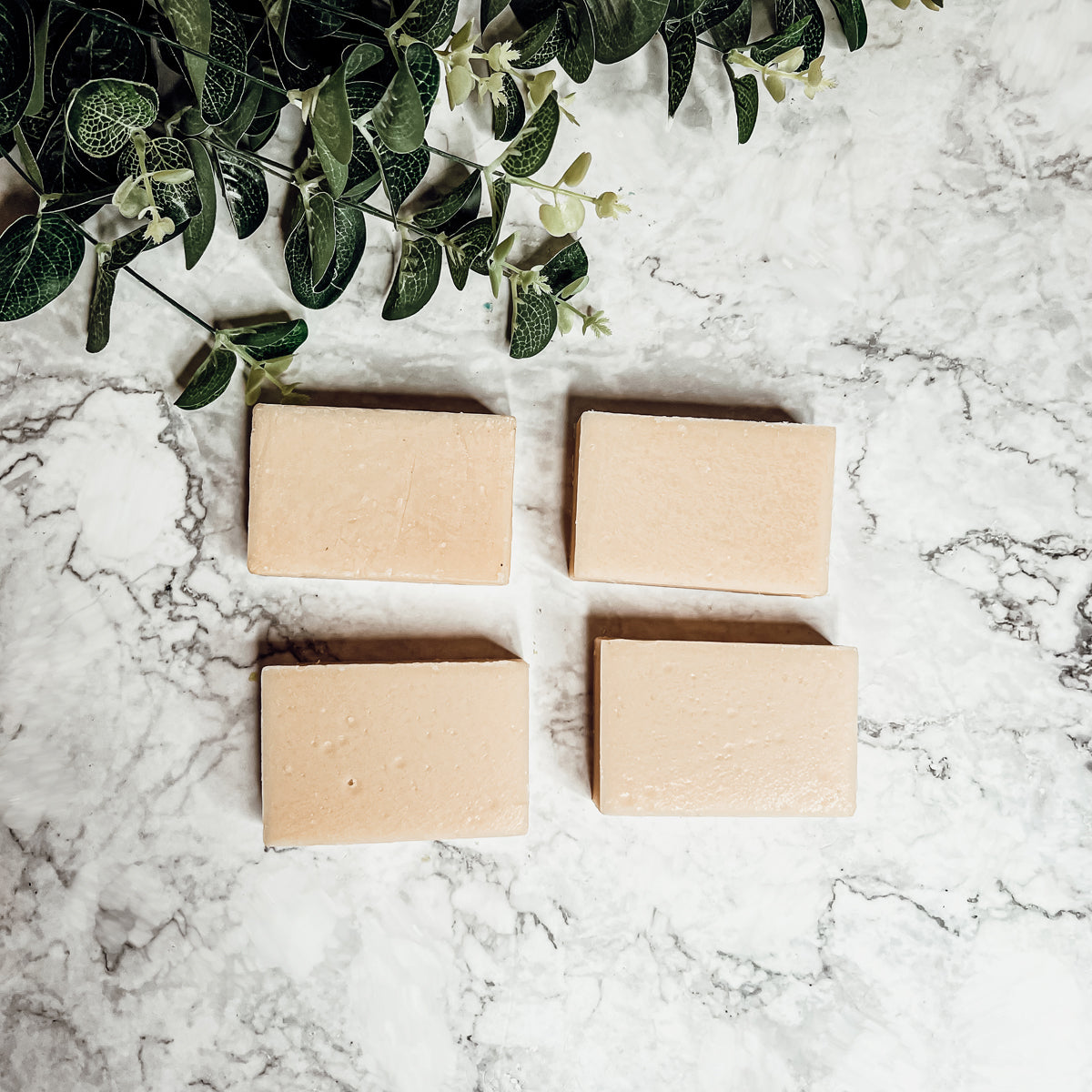 A handcrafted bar of Apple Spice soap featuring a warm blend of sweet red apples, cinnamon, and clove, showcasing its unique design and colors.