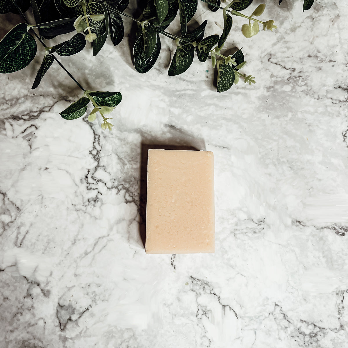 A handcrafted bar of Apple Spice soap featuring a warm blend of sweet red apples, cinnamon, and clove, showcasing its unique design and colors.