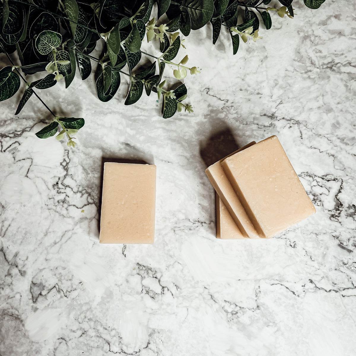 A handcrafted bar of Apple Spice soap featuring a warm blend of sweet red apples, cinnamon, and clove, showcasing its unique design and colors.