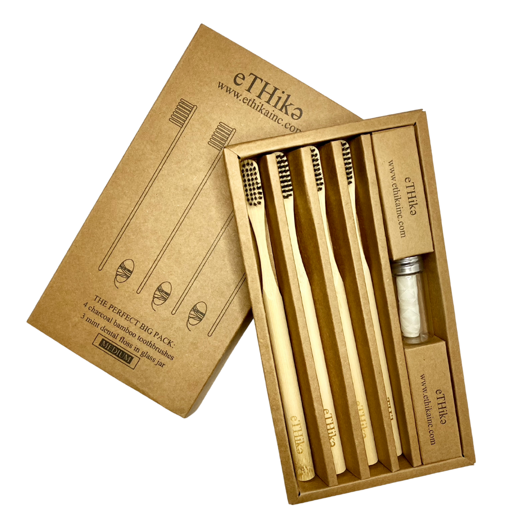 Bamboo Oral Hygiene Care Set of 7 featuring charcoal toothbrushes and mint floss in a glass container, showcasing eco-friendly dental care.