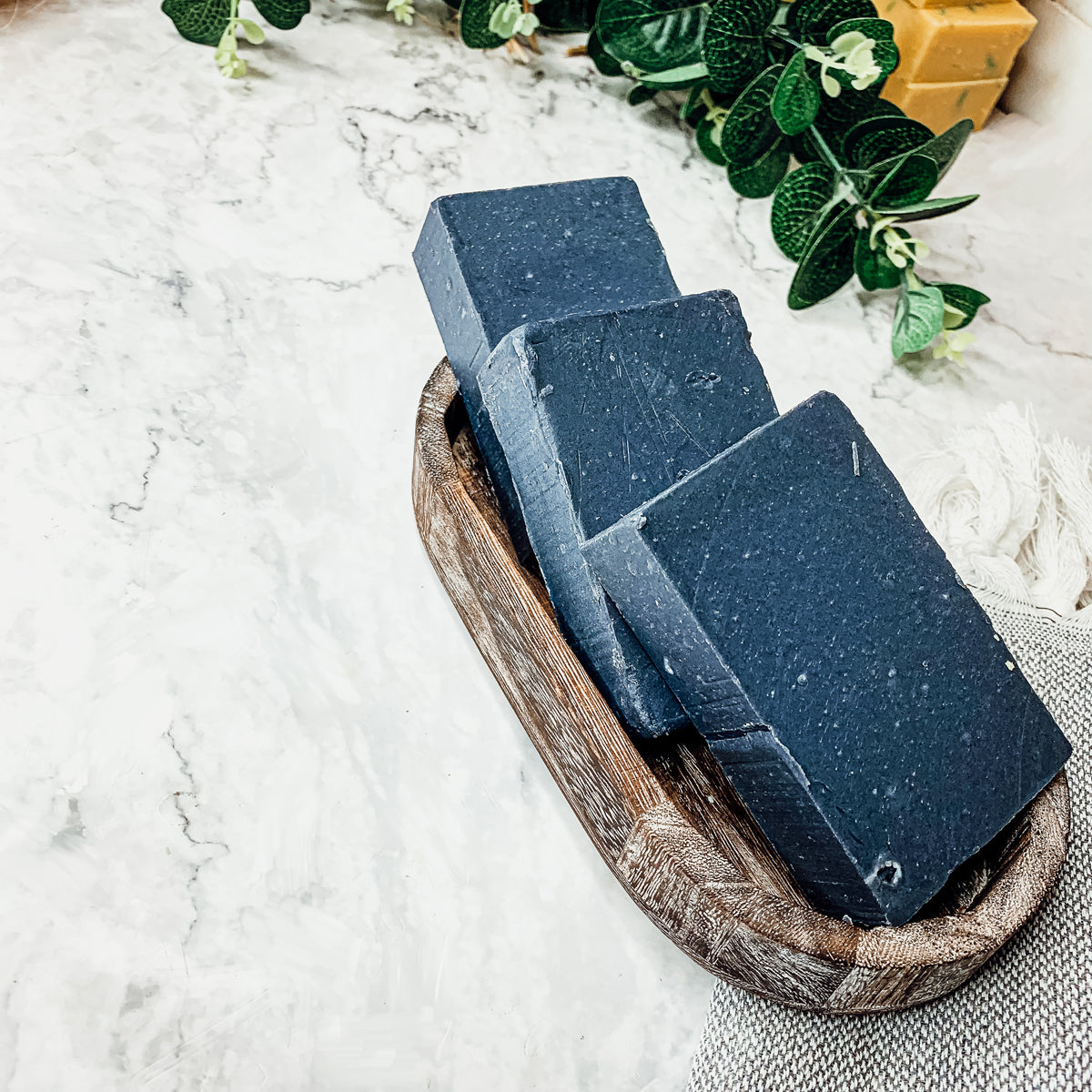 A bar of Black Soap showcasing its rich texture and natural ingredients, ideal for sensitive skin.