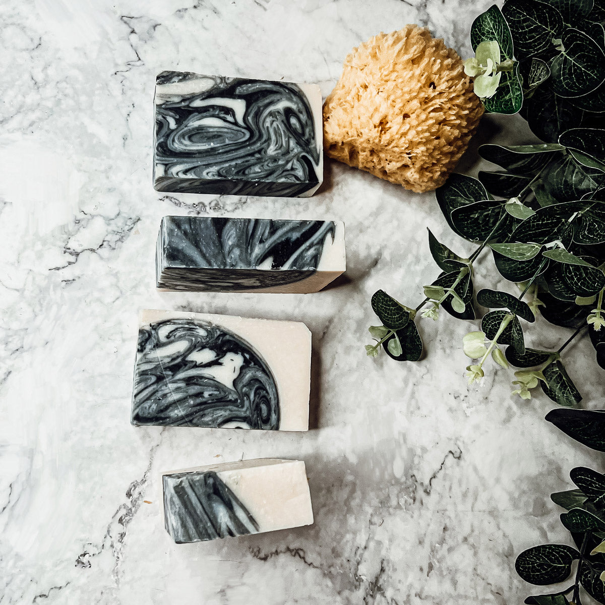 Black Storm soap bar featuring a clean masculine scent with activated charcoal, patchouli, and sandalwood, handcrafted in small batches.