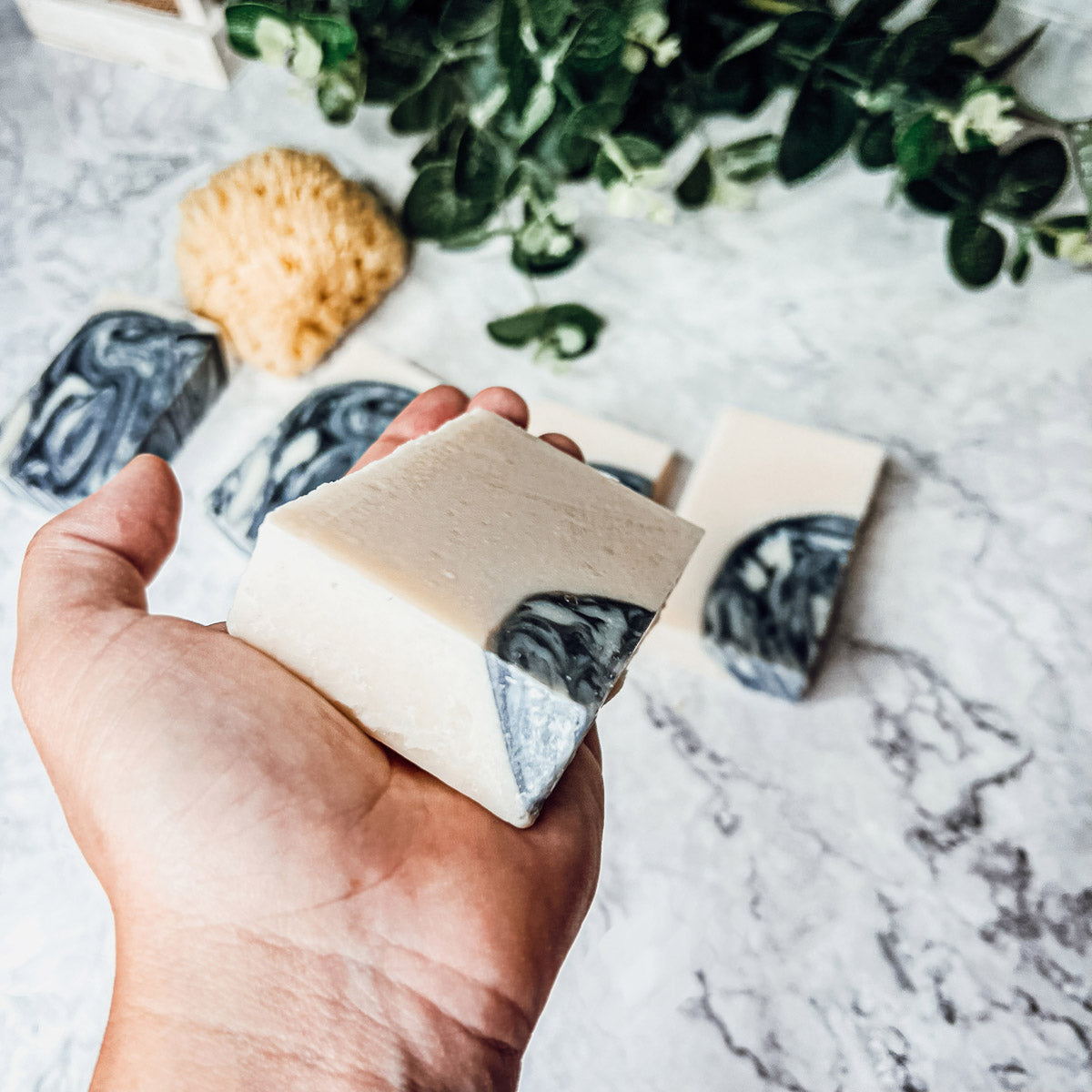 Black Storm soap bar featuring a clean masculine scent with activated charcoal, patchouli, and sandalwood, handcrafted in small batches.