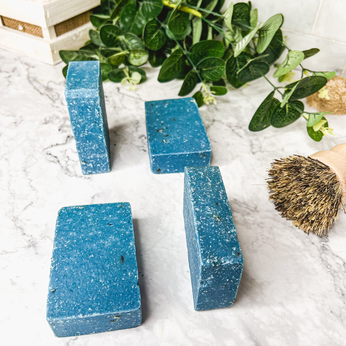 A vibrant blue bar of Blueberry Scrub soap with visible oatmeal and sea salt, showcasing its handcrafted design and rich color.