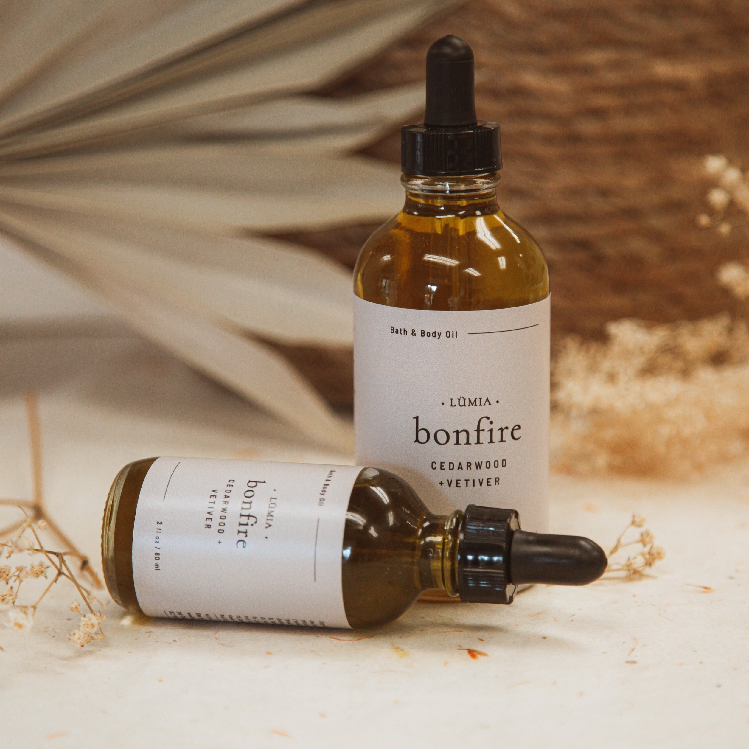 Bonfire Bath & Body Oil bottle with earthy design, showcasing its natural ingredients and soothing aroma.