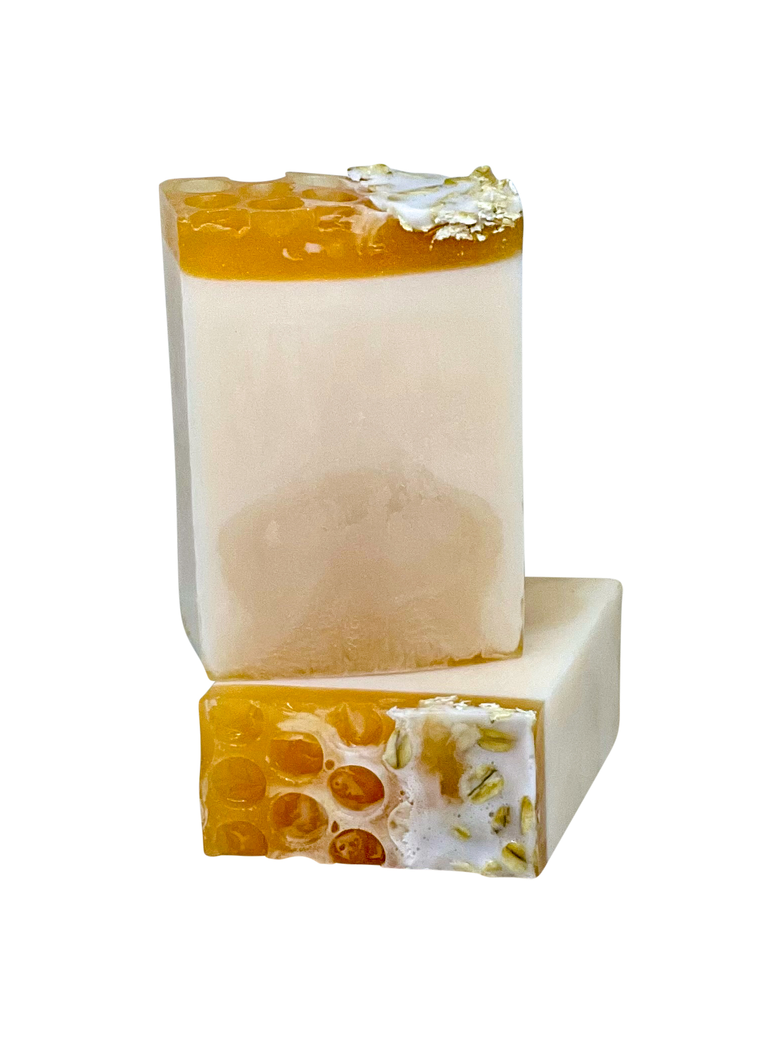 Buzz Off Milk & Honey Soap featuring a creamy texture, gold honeycomb accents, and fresh oats on top, perfect for a luxurious bathing experience.