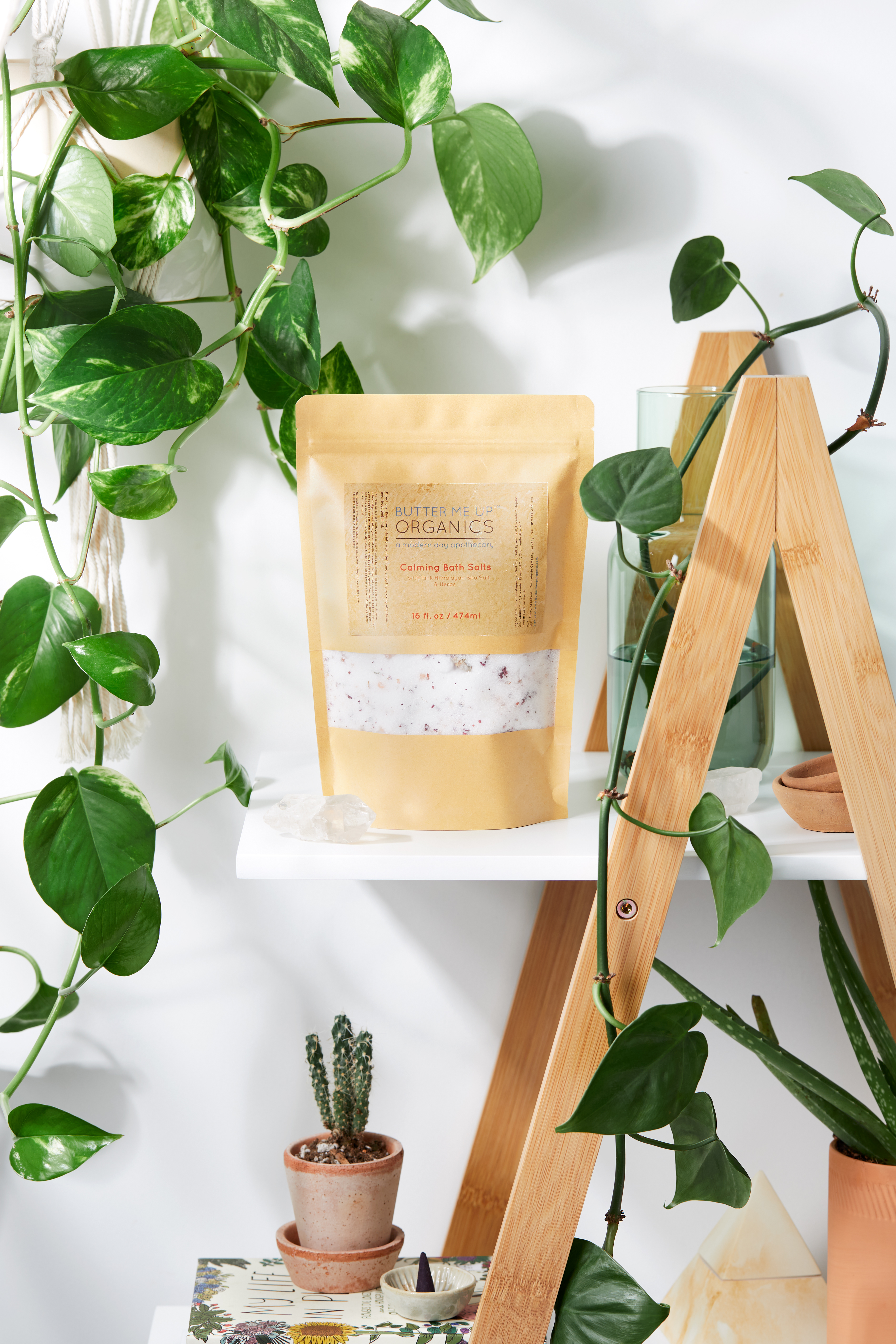 A resealable kraft glassine bag filled with Calming Bath Salts, featuring a blend of Epsom, Pink Himalayan, and Sea Salts, infused with lavender and chamomile.