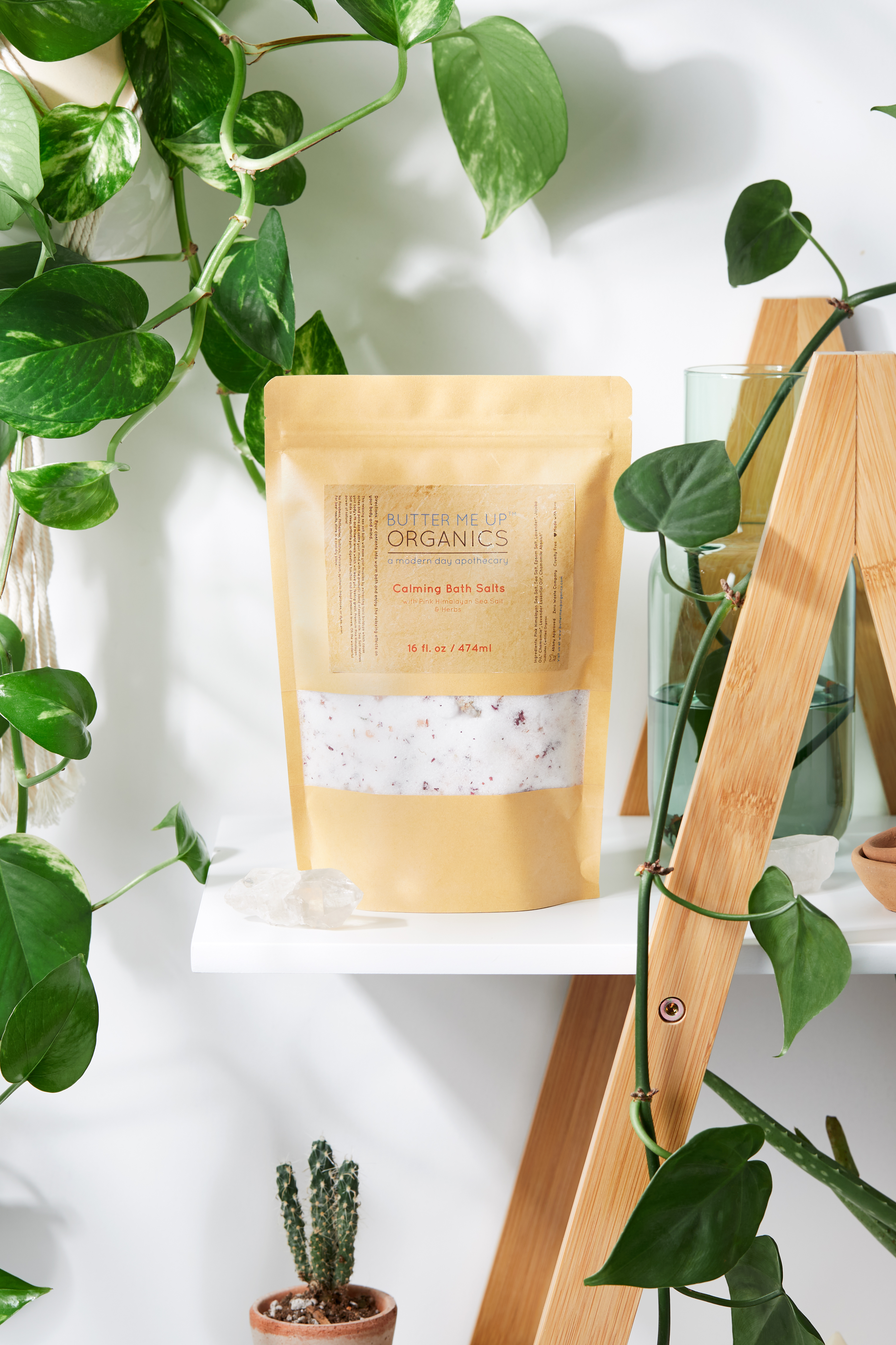 A resealable kraft glassine bag filled with Calming Bath Salts, featuring a blend of Epsom, Pink Himalayan, and Sea Salts, infused with lavender and chamomile.