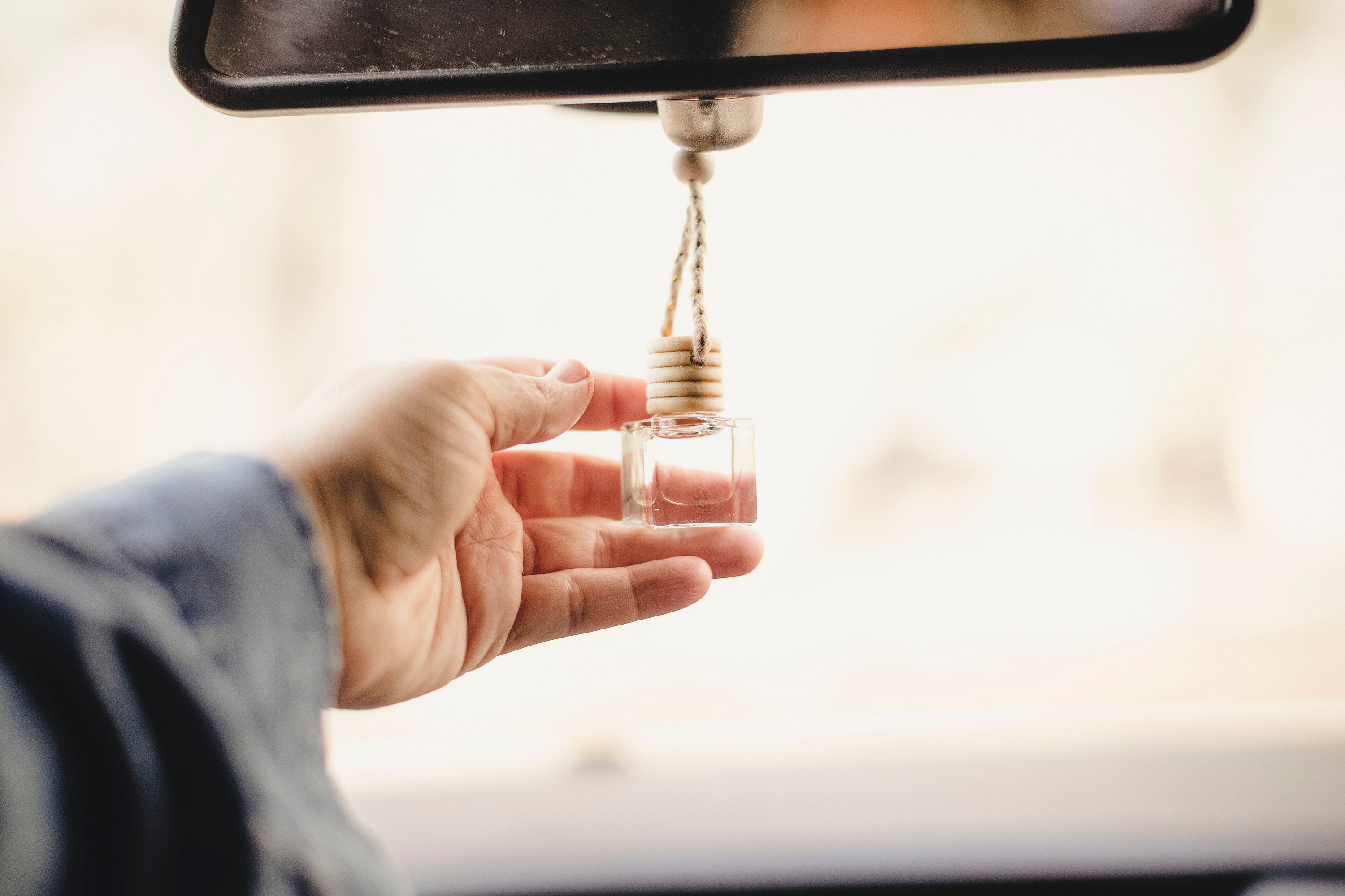 A stylish hanging car diffuser filled with 8ml of unique fragrance blends, designed to enhance the car's interior aroma.