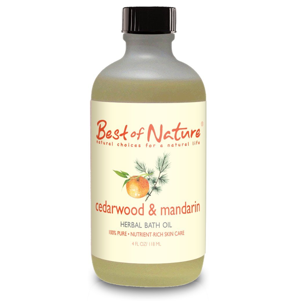 A bottle of Cedarwood & Mandarin Bath Oil surrounded by natural ingredients like coconut and mandarin oranges, showcasing its soothing properties.