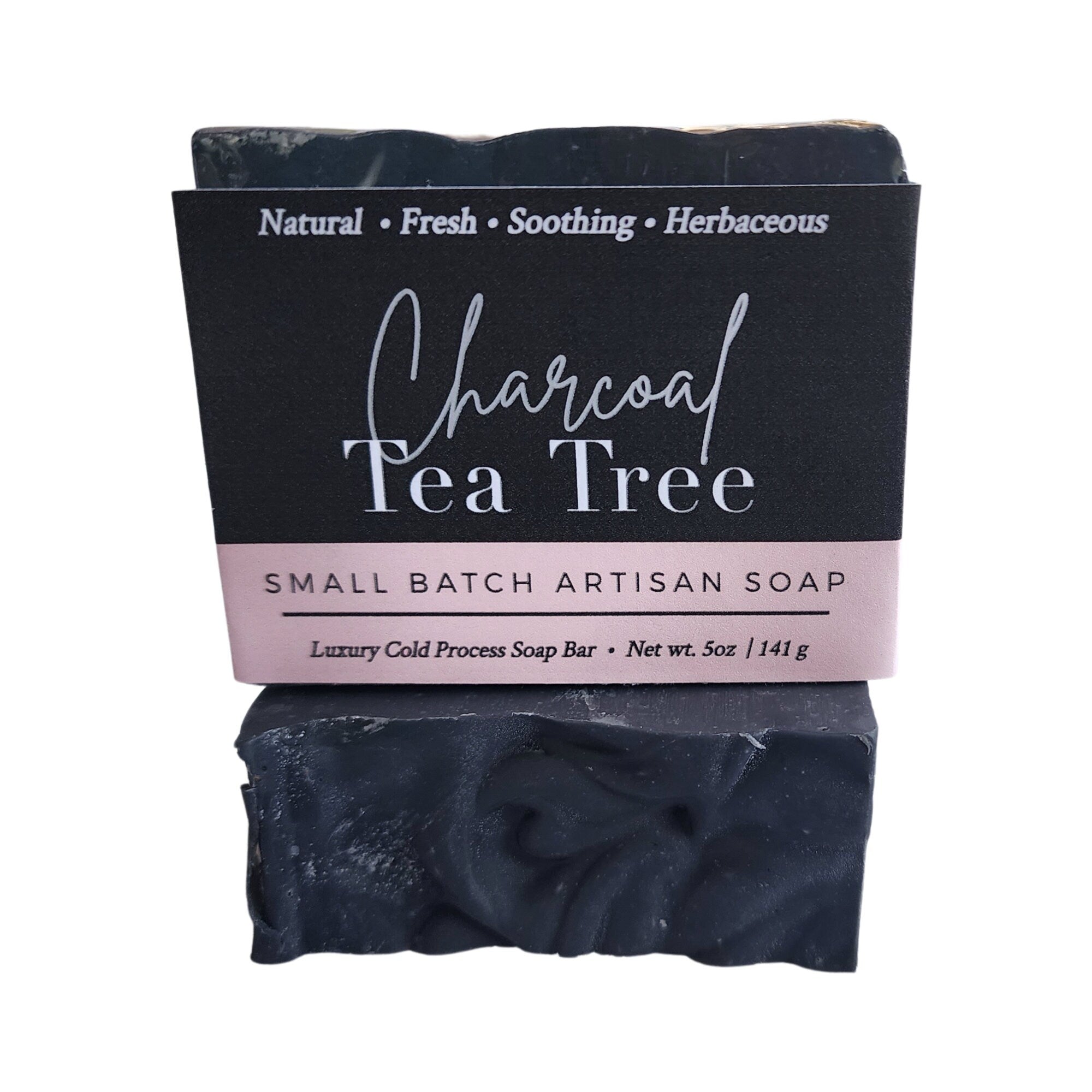 A sleek and rich Charcoal Tea Tree Soap bar, showcasing its dark color and natural ingredients, perfect for deep cleansing.