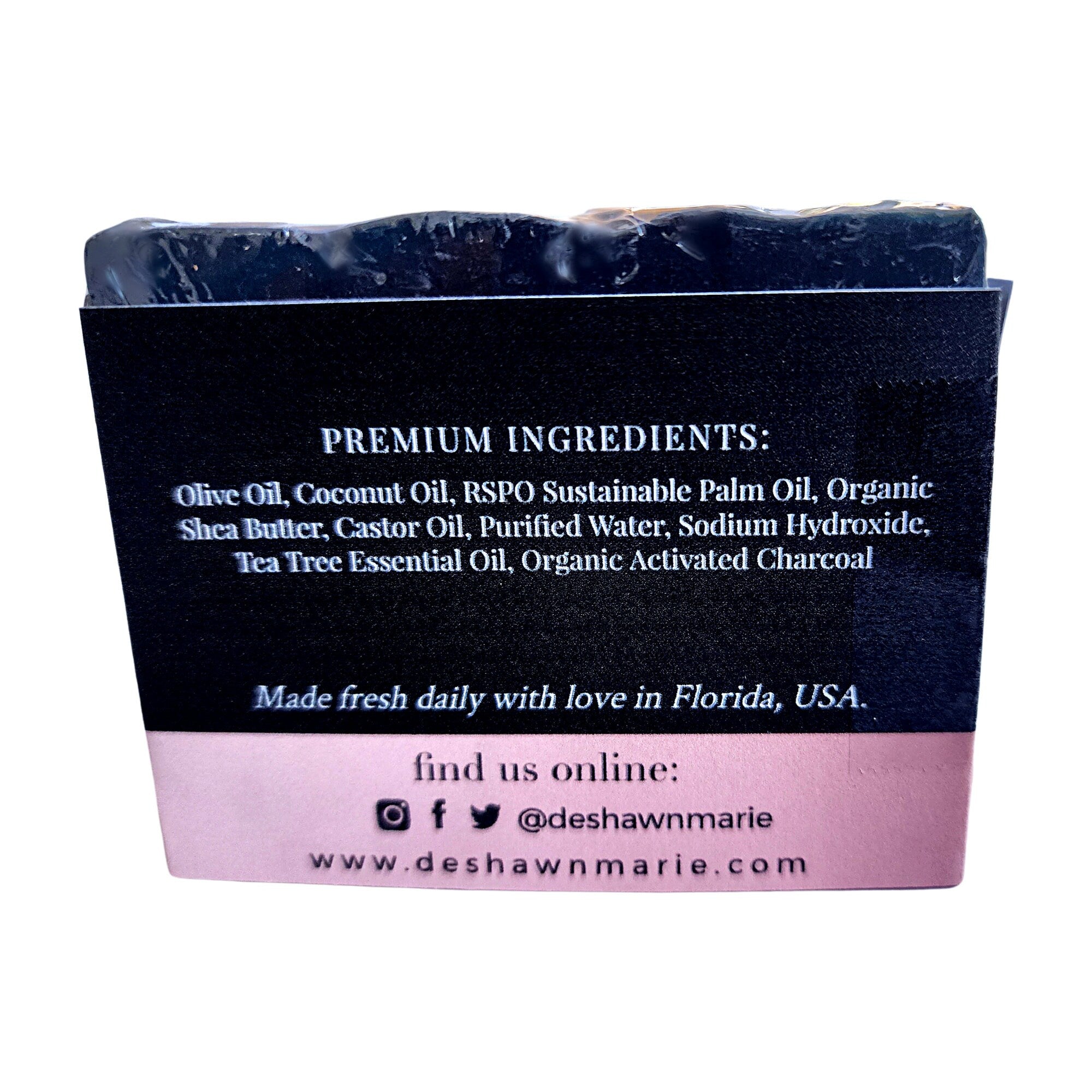 A sleek and rich Charcoal Tea Tree Soap bar, showcasing its dark color and natural ingredients, perfect for deep cleansing.