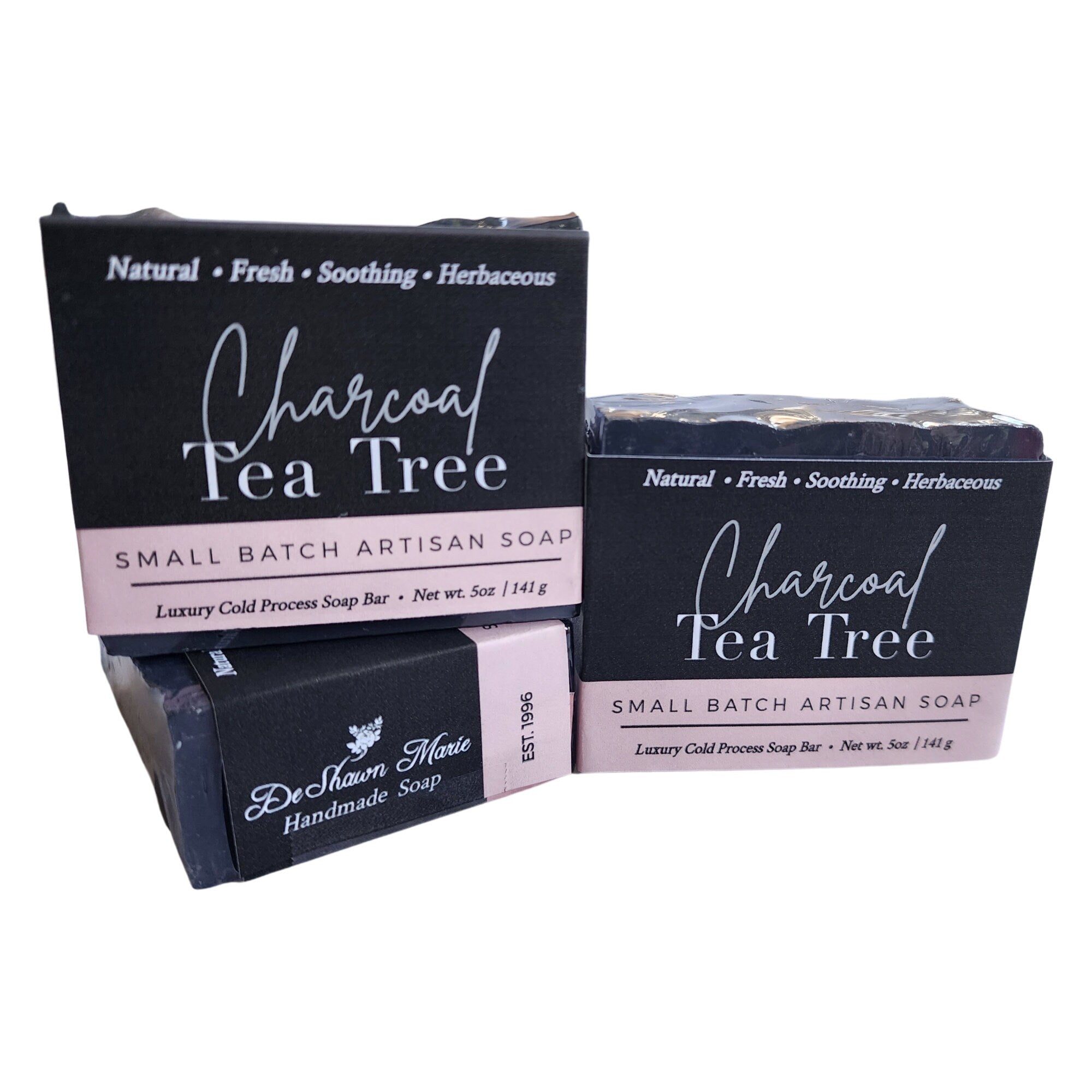 A sleek and rich Charcoal Tea Tree Soap bar, showcasing its dark color and natural ingredients, perfect for deep cleansing.