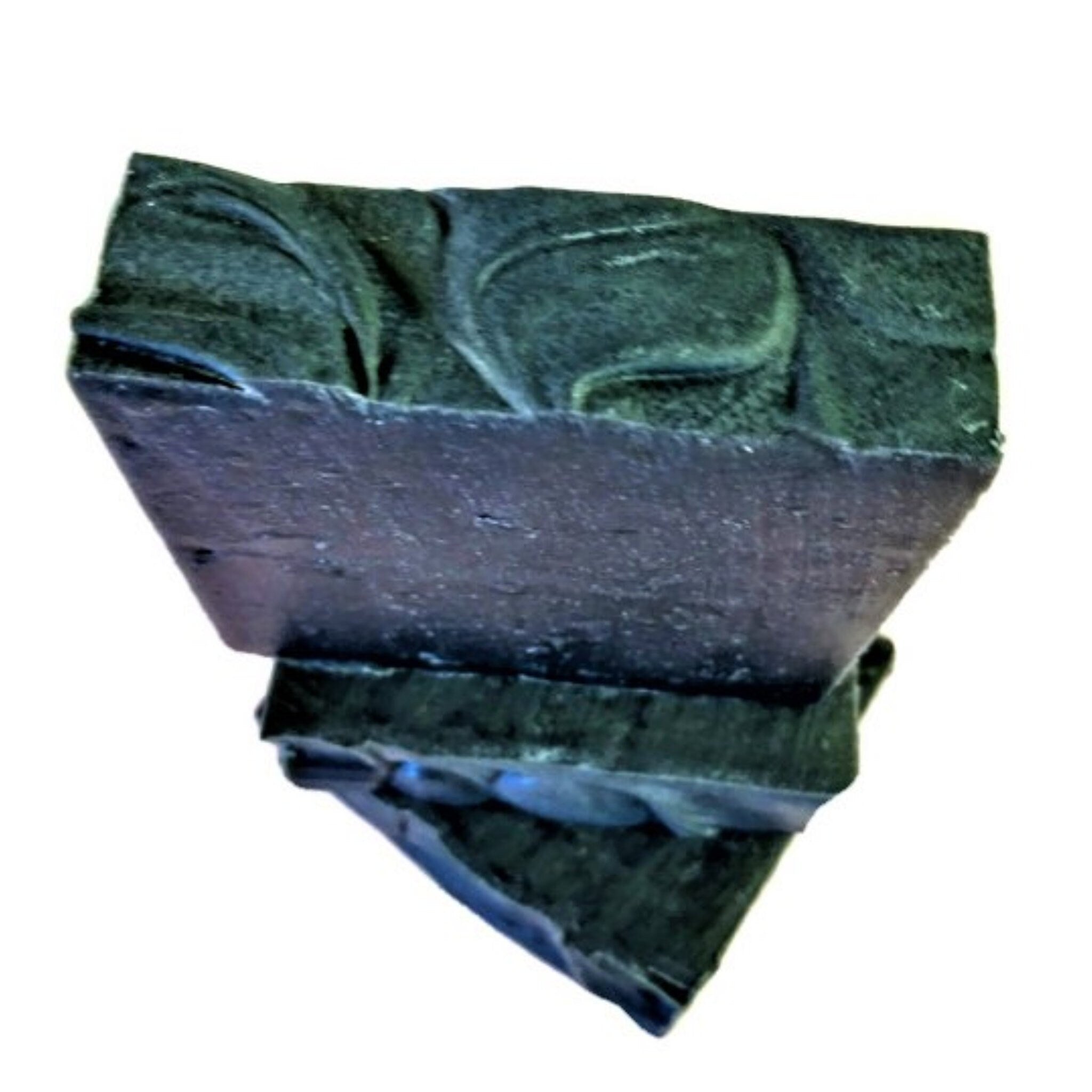 A sleek and rich Charcoal Tea Tree Soap bar, showcasing its dark color and natural ingredients, perfect for deep cleansing.