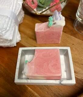 Cherry Bloom soap with swirled design and flower icing, showcasing its vibrant colors and handcrafted quality.