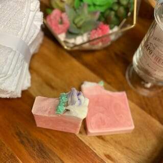 Cherry Bloom soap with swirled design and flower icing, showcasing its vibrant colors and handcrafted quality.