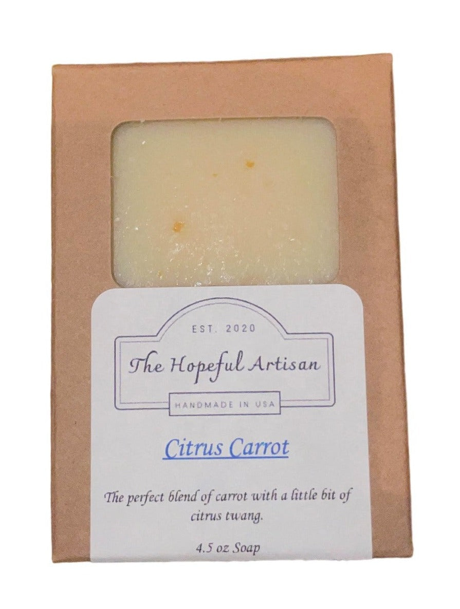 Citrus Carrot soap bar with vibrant colors and unique swirls, showcasing natural ingredients like dried carrots and organic shea butter.