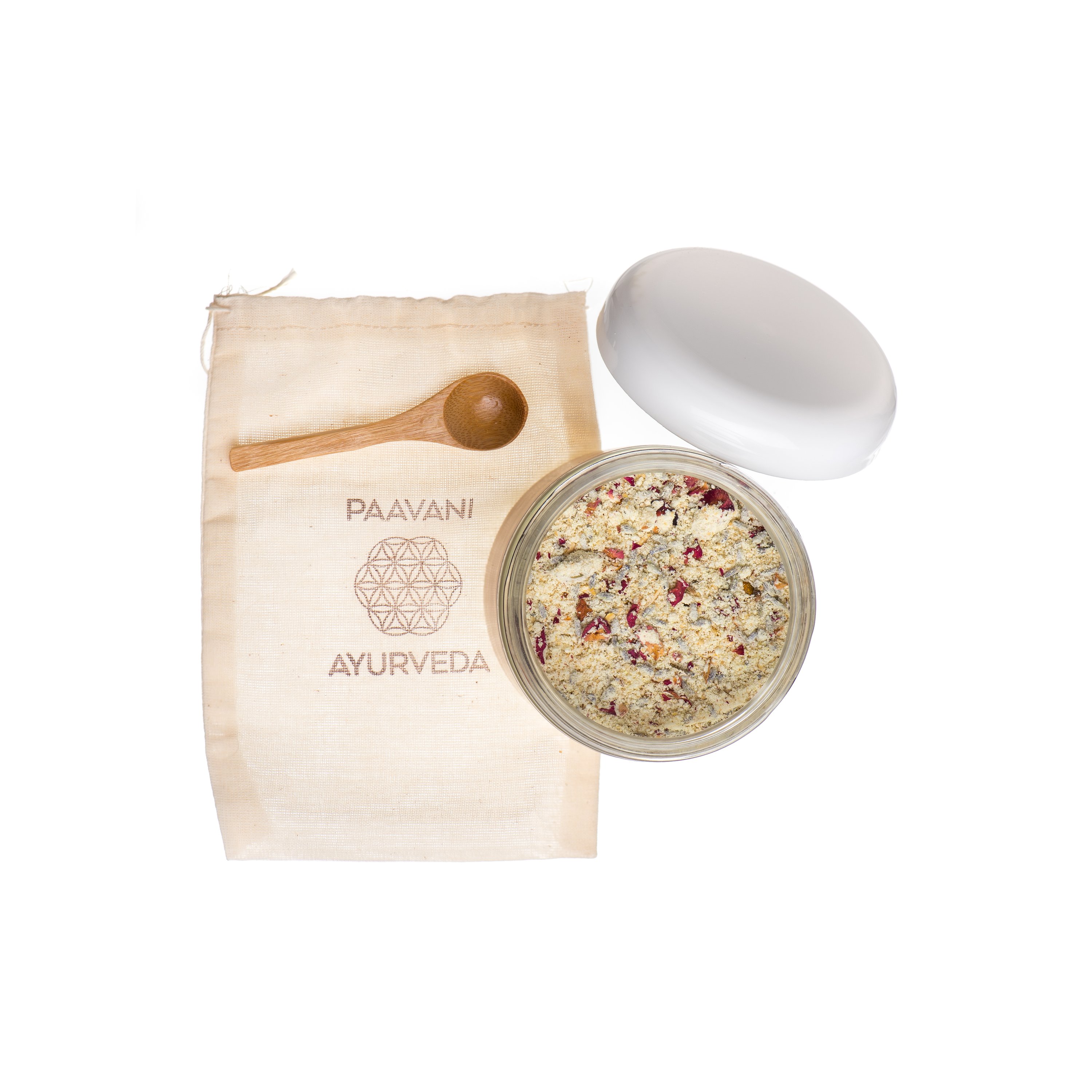 A luxurious Coconut Milk Bath jar with a muslin pouch and bamboo spoon, showcasing its natural ingredients.