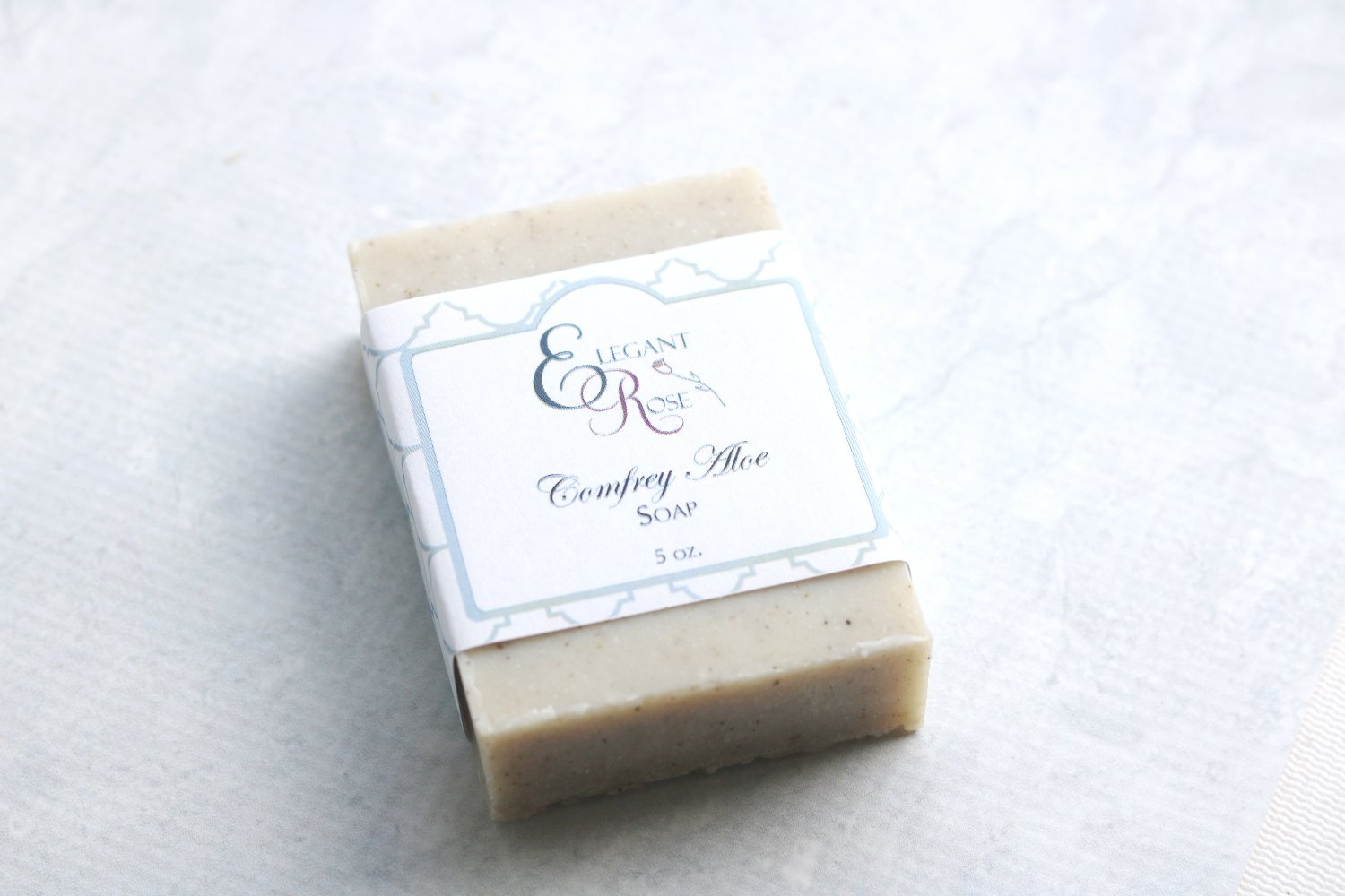 A bar of Comfrey & Aloe Soap showcasing its natural ingredients, with a smooth texture and earthy tones, ideal for gentle skin care.