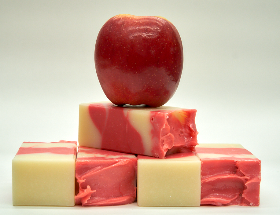 A bar of Country Apple Soap with a complex scent of apples, pineapple, and vanilla, showcasing its handcrafted quality.