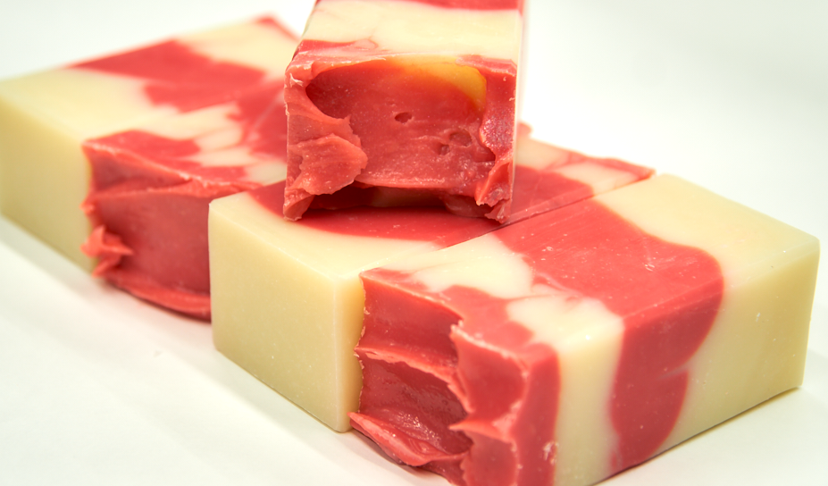 A bar of Country Apple Soap with a complex scent of apples, pineapple, and vanilla, showcasing its handcrafted quality.