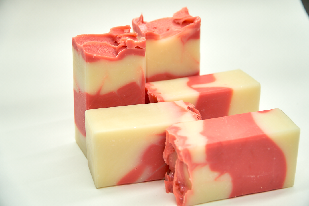 A bar of Country Apple Soap with a complex scent of apples, pineapple, and vanilla, showcasing its handcrafted quality.