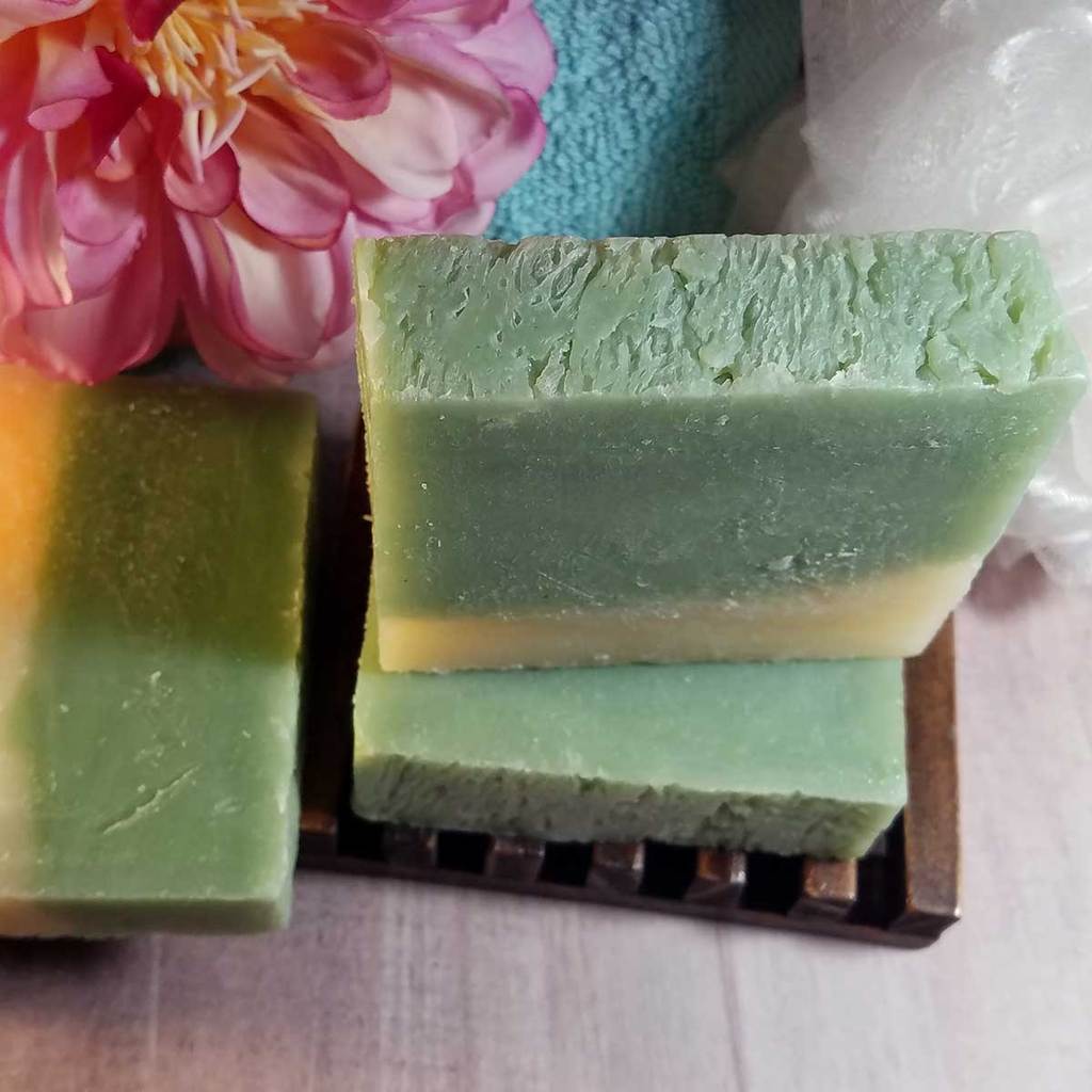 Cucumber and Melon Handmade Soap bar with fresh cucumber and melon slices, showcasing its vibrant colors and natural ingredients.