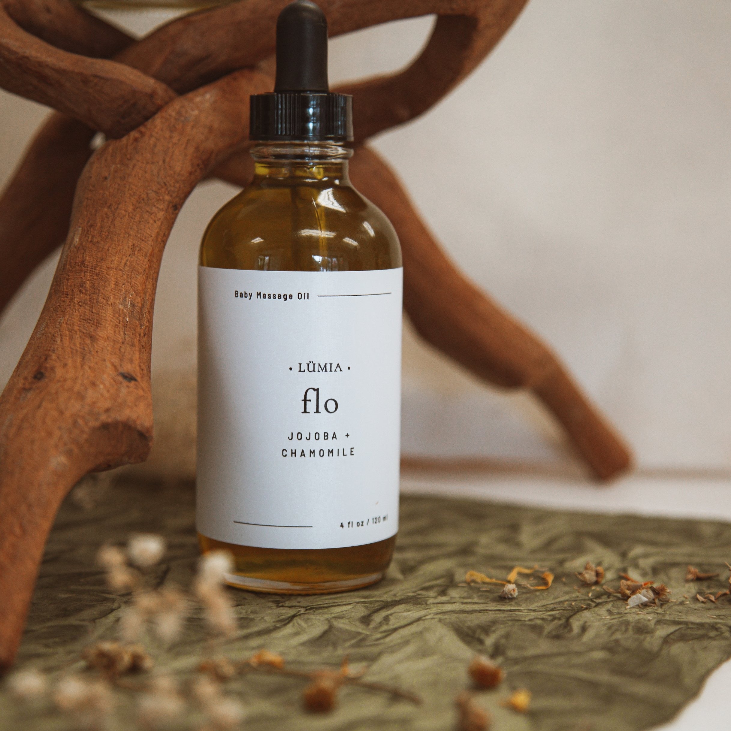 Flo Sensitive Skin Massage Oil in a 4 oz bottle, featuring a blend of Jojoba, Calendula, Lavender, and Chamomile oils for baby skin care.