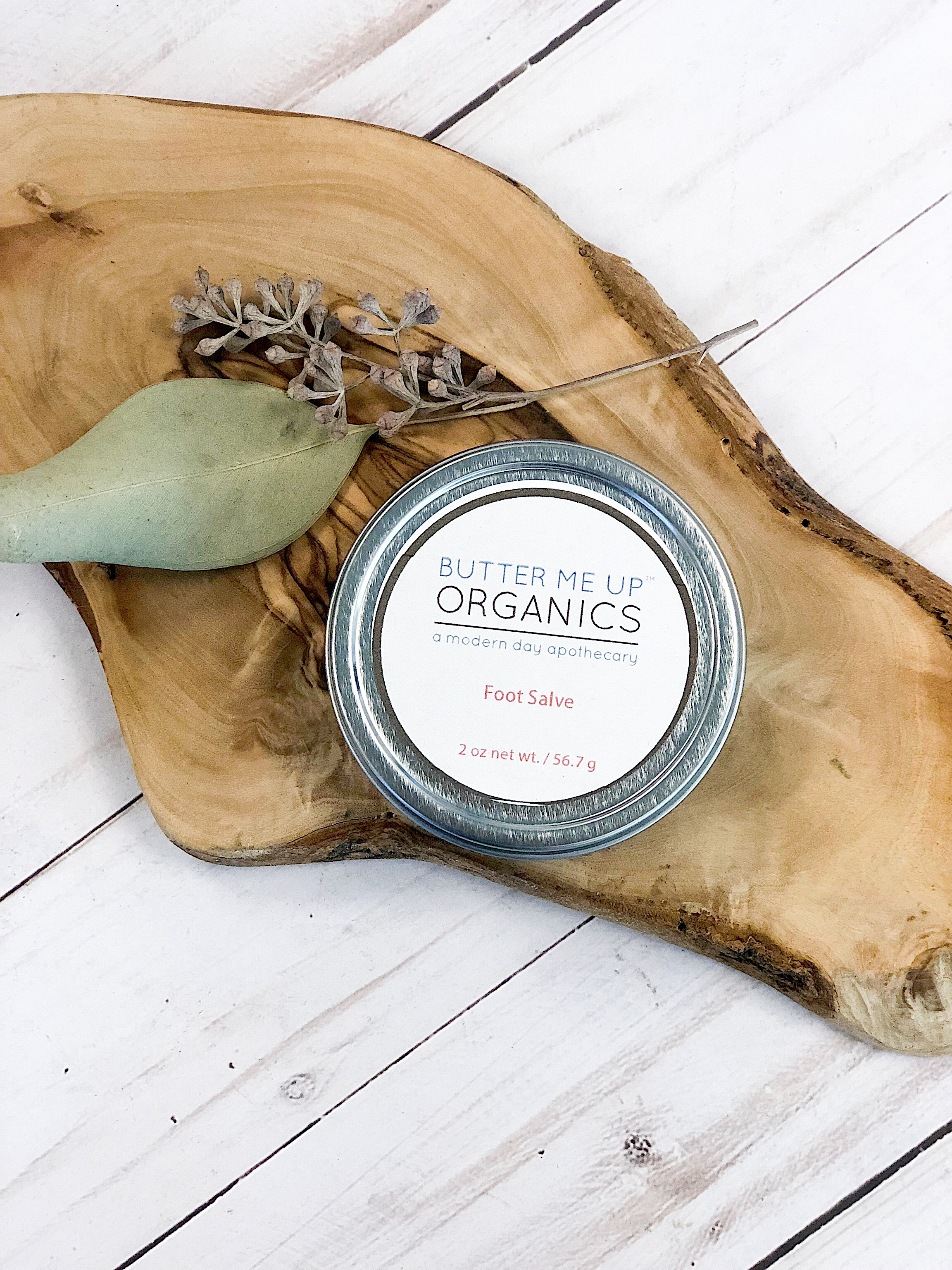 A 2oz tin of Foot Salve featuring a blend of natural butters and oils, designed to hydrate and repair cracked heels and rough feet.