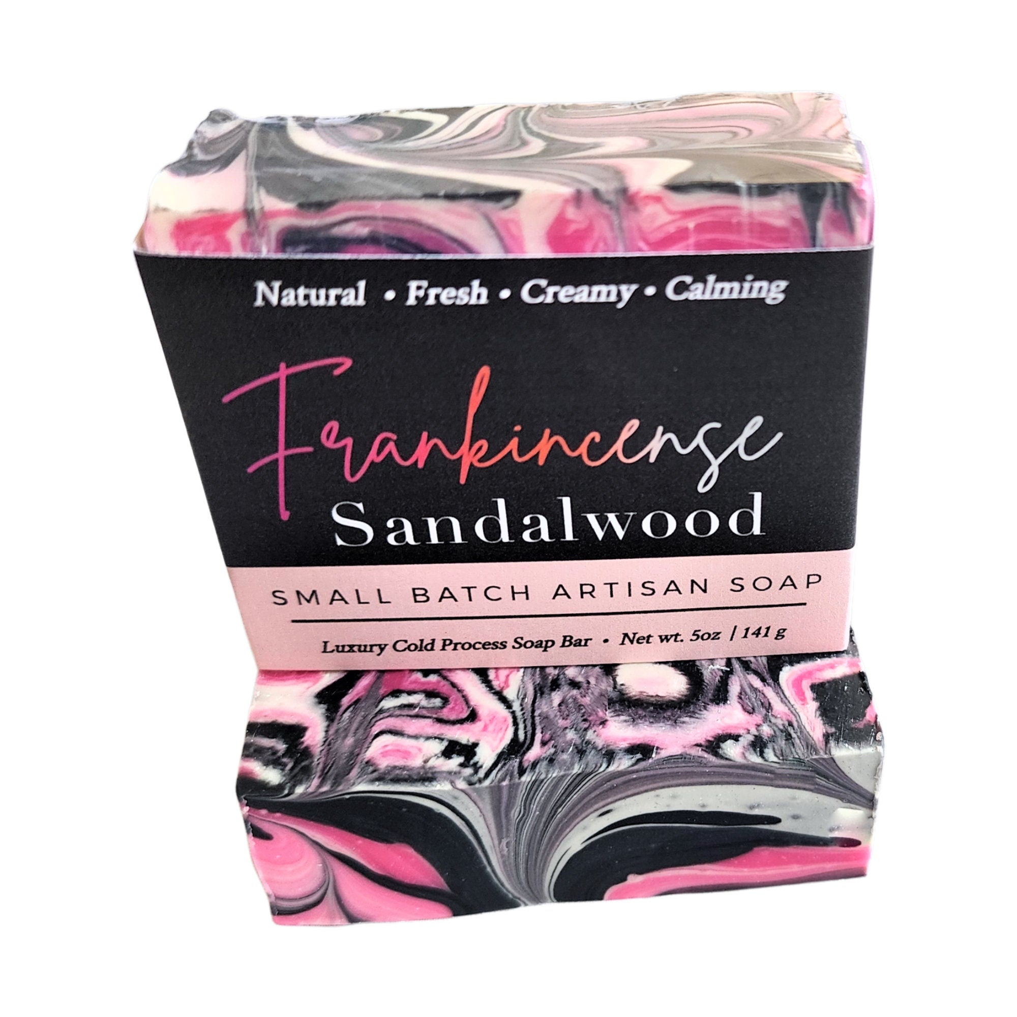 A beautifully crafted Frankincense Sandalwood Soap bar featuring pink, black, and white swirls, showcasing its unique design and vegan ingredients.