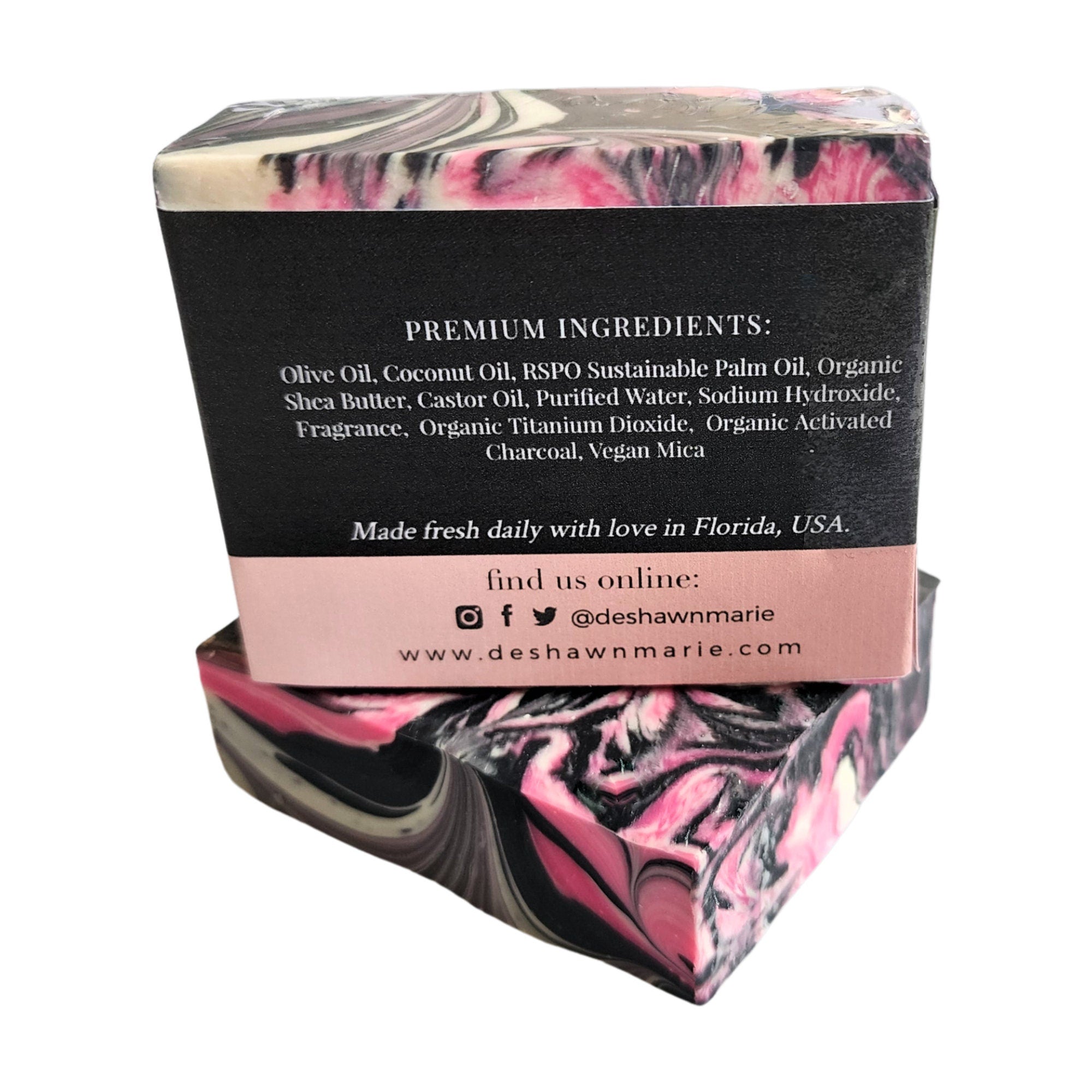 A beautifully crafted Frankincense Sandalwood Soap bar featuring pink, black, and white swirls, showcasing its unique design and vegan ingredients.