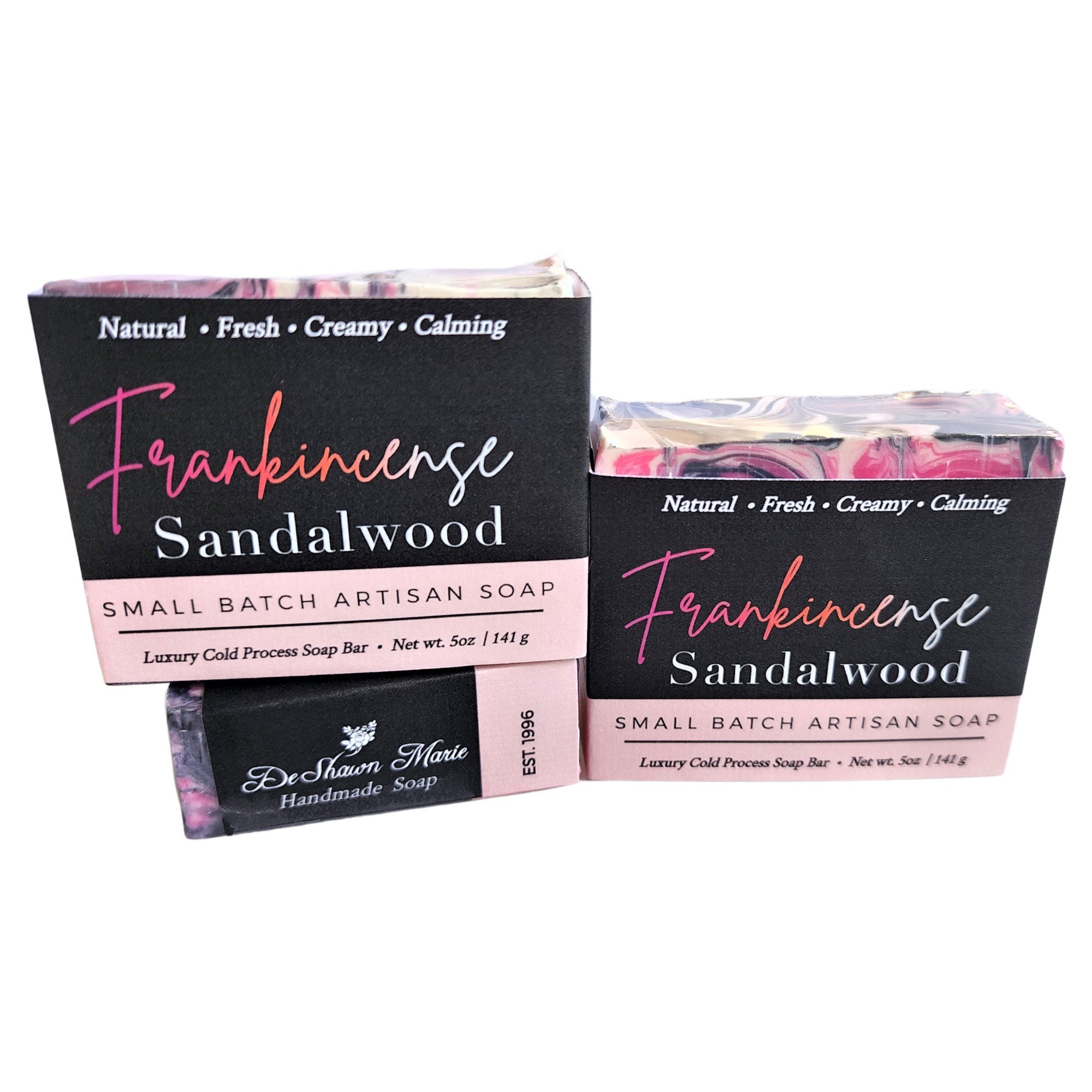 A beautifully crafted Frankincense Sandalwood Soap bar featuring pink, black, and white swirls, showcasing its unique design and vegan ingredients.