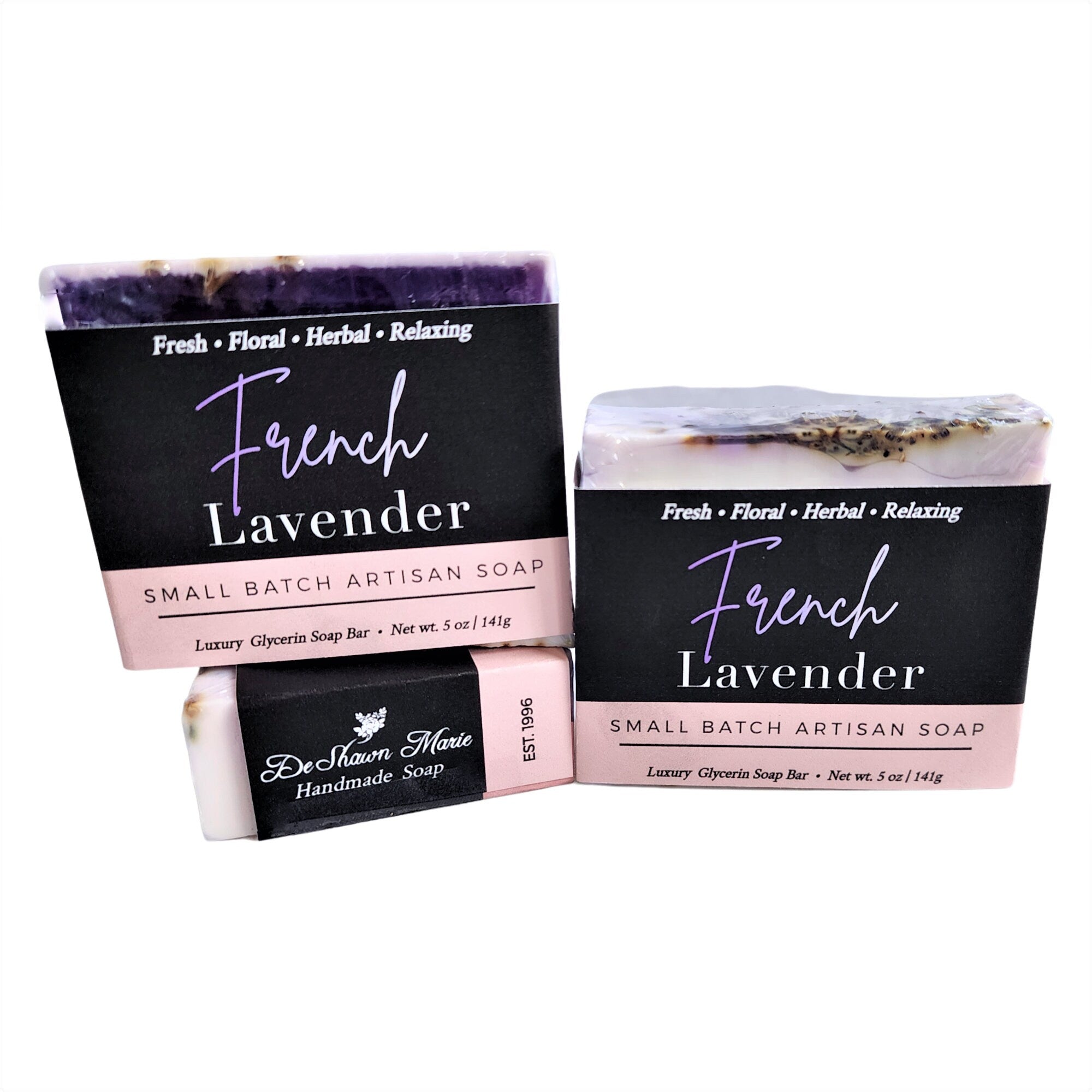 A beautifully crafted bar of French Lavender Soap with dried lavender flowers embedded, showcasing its rich purple hue and artisanal quality.